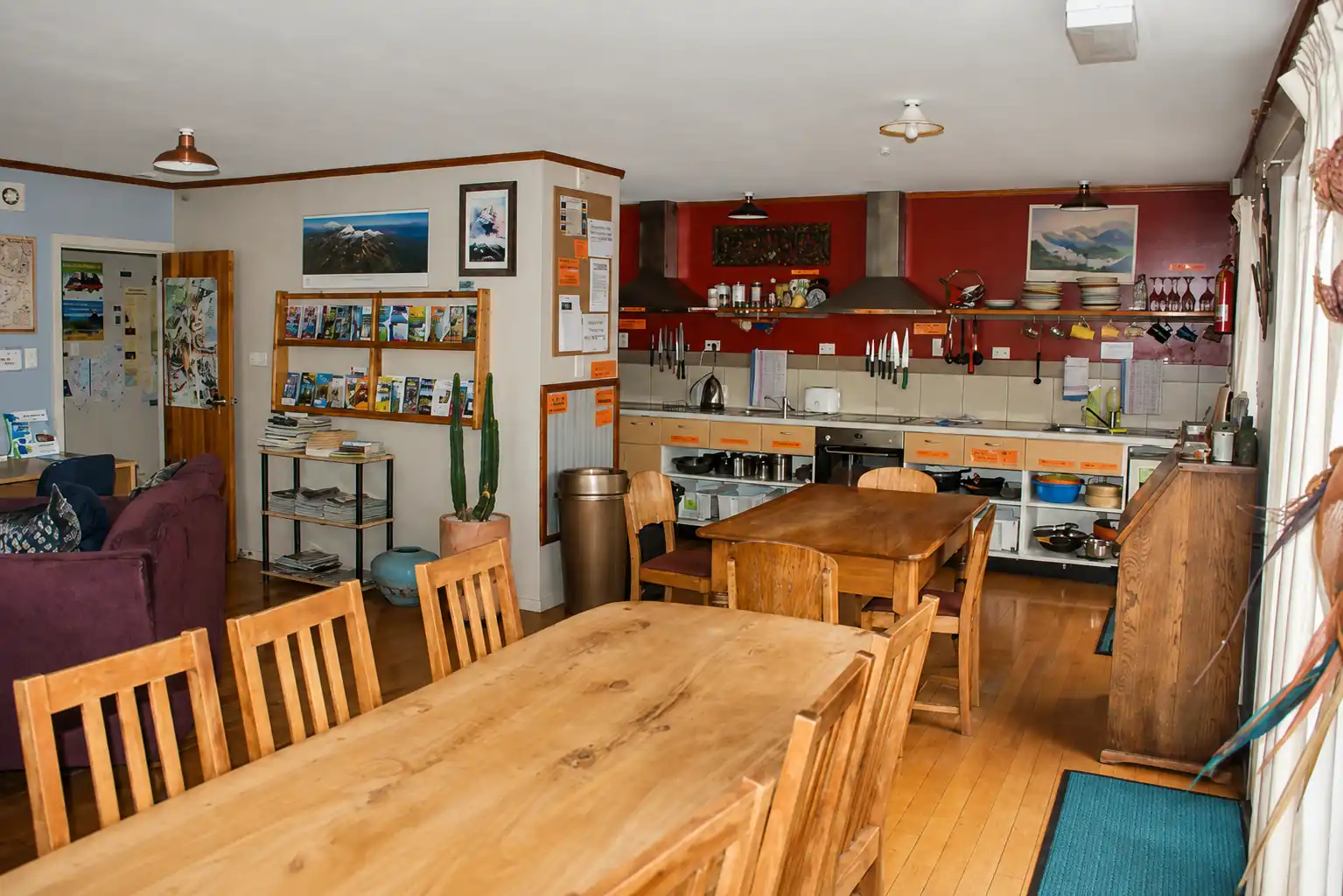 Large shared kitchen with oven, preparation benches and timber dining tables